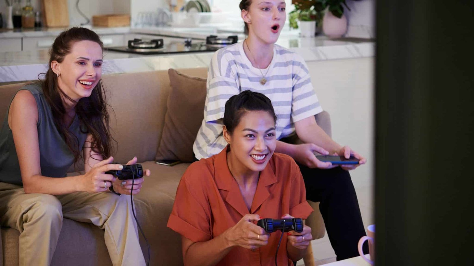 Friends playing video games in a living room
