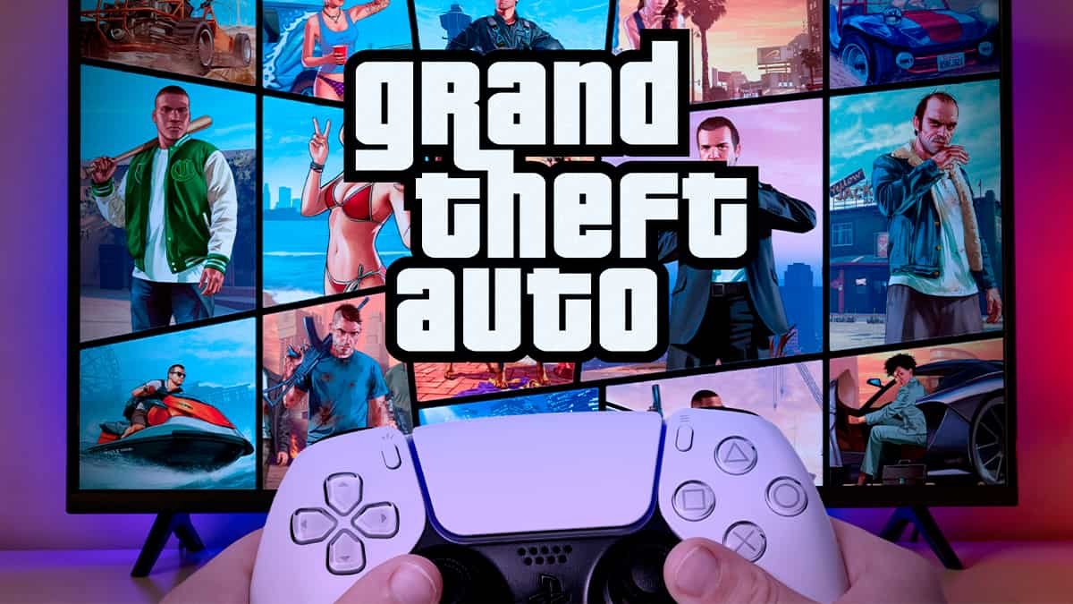 Person holding a PlayStation 5 controller in front of a TV showing GTA V