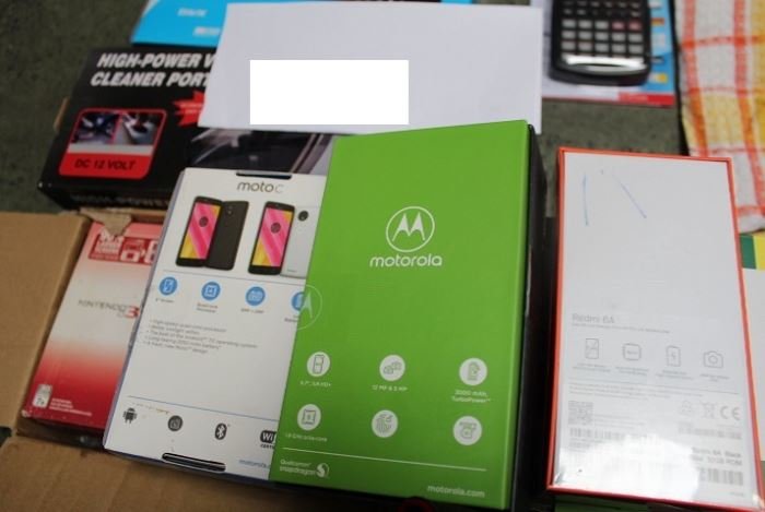 Lot 7 contents: a Moto C smartphone and assorted electronics