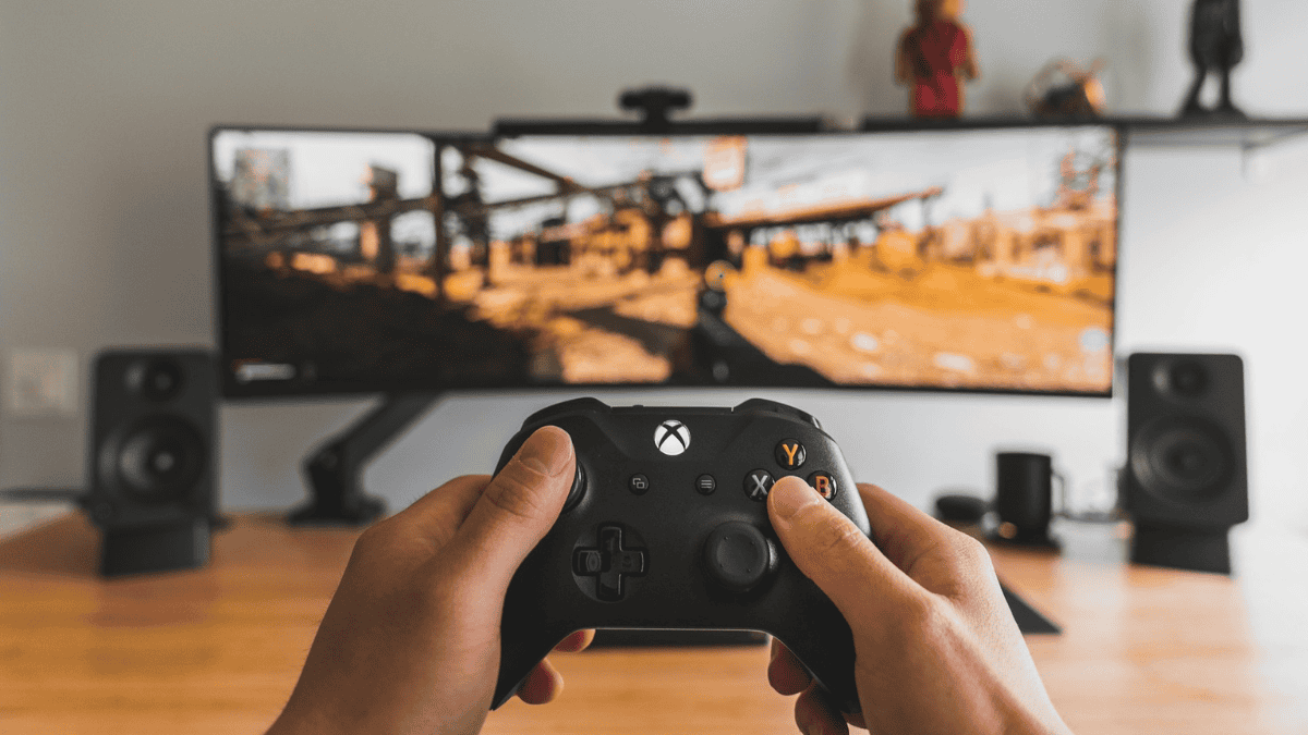 Gamer using an Xbox on a large monitor