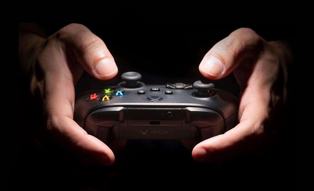 Xbox controller beside a console and screen