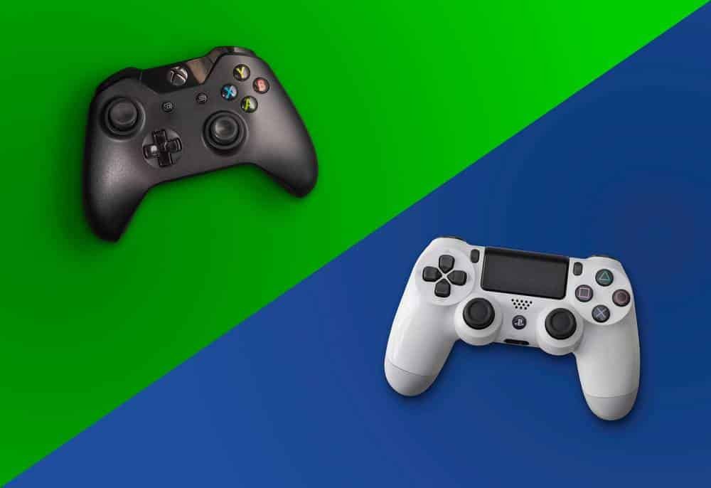 person holding a PS4 controller beside a console being prepared for sale