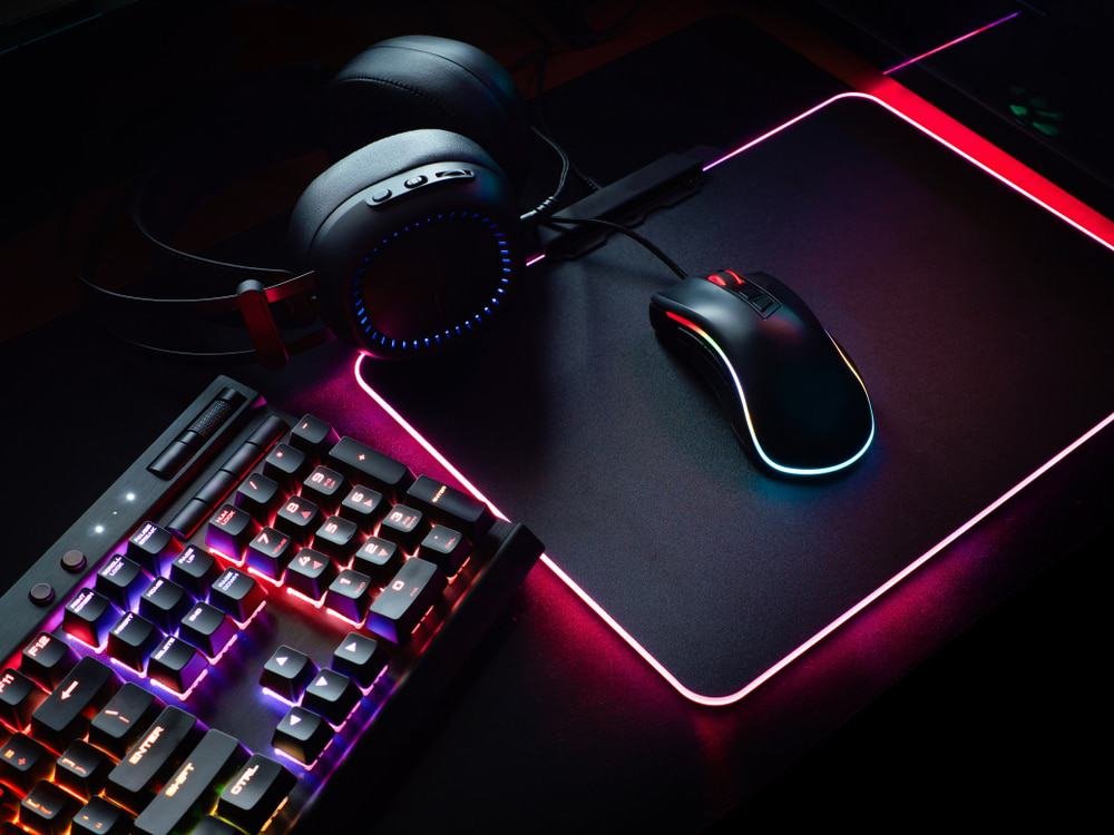 Hands typing on a keyboard beside a controller