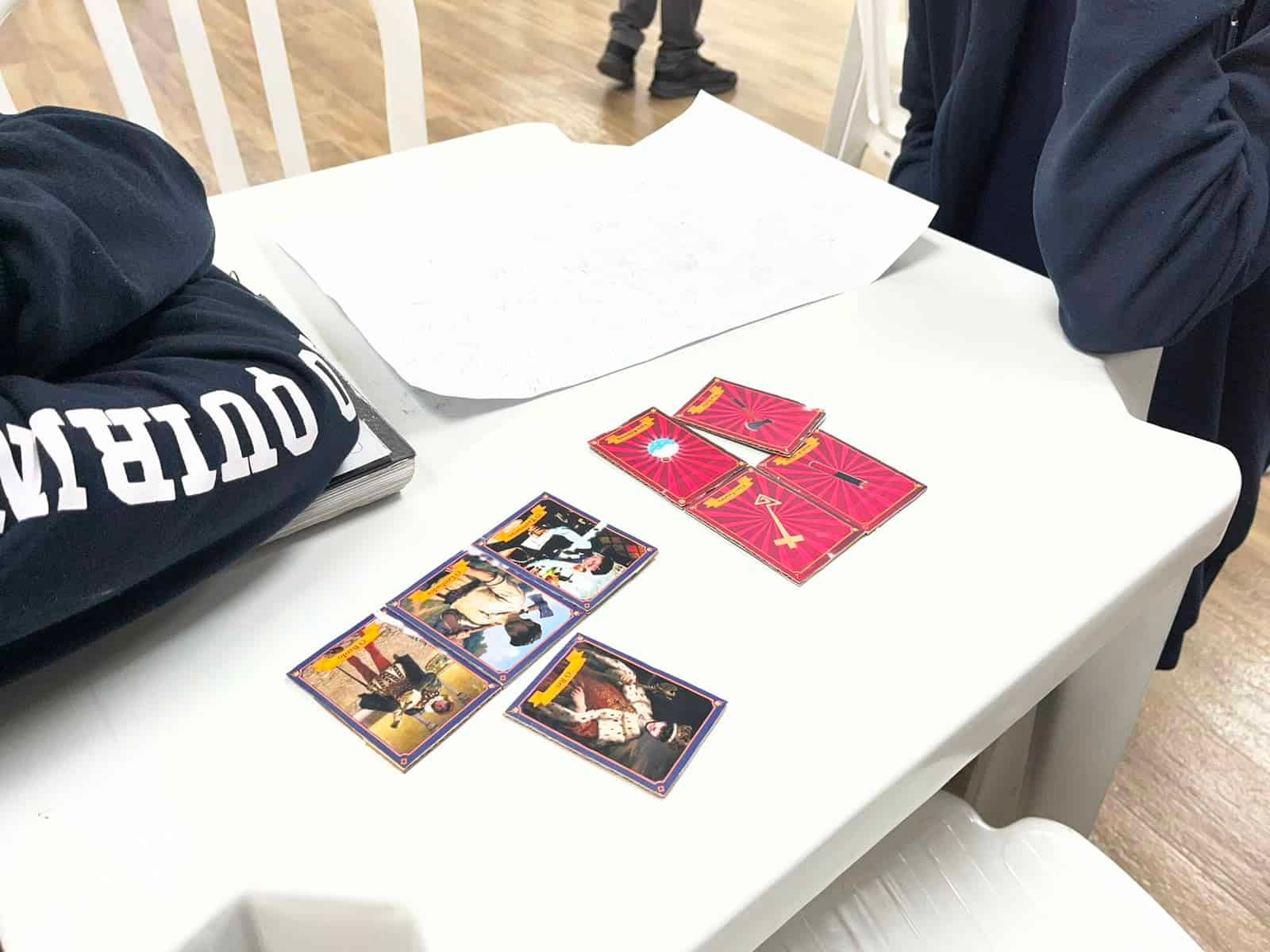 Box and components of the board game Morbus Imperium on a table with cards and tokens