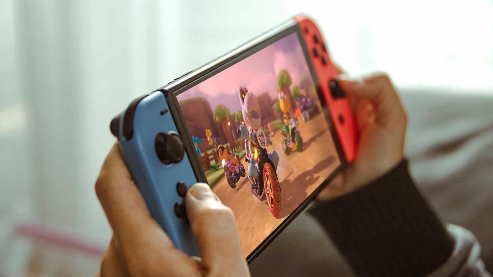 Young person playing a portable Nintendo console