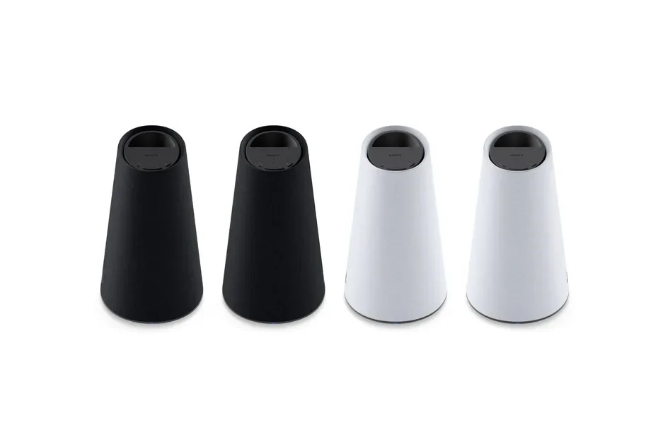 Two Pulse Elevate wireless speakers on a desk beside a console