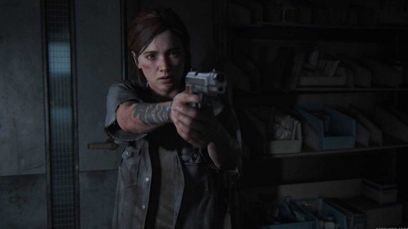 Ellie aiming a weapon during a tense moment in-game