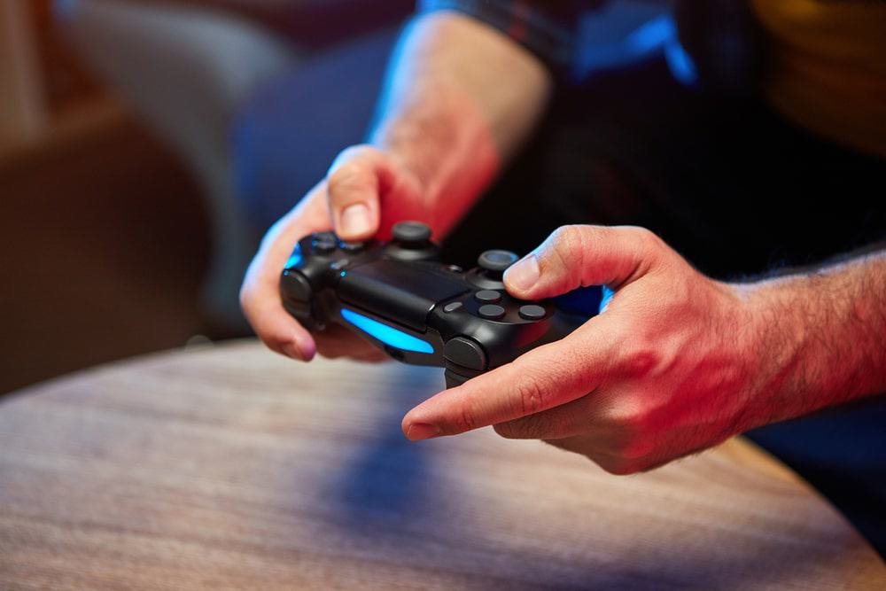 Hands adjusting a video game controller during play