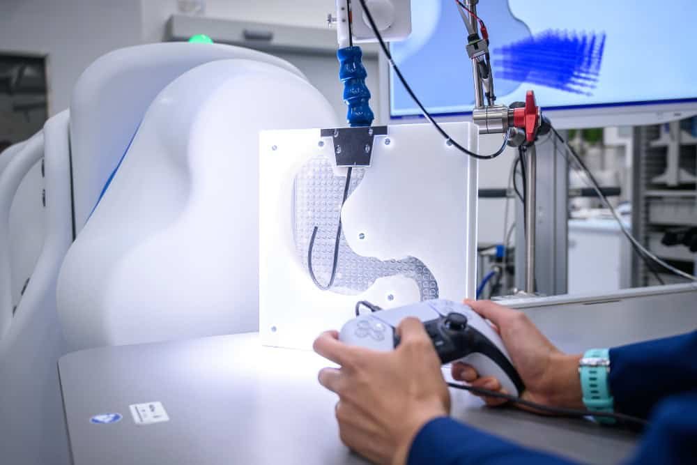 Surgeon demonstrating a PlayStation controller used to operate the remote endoscope