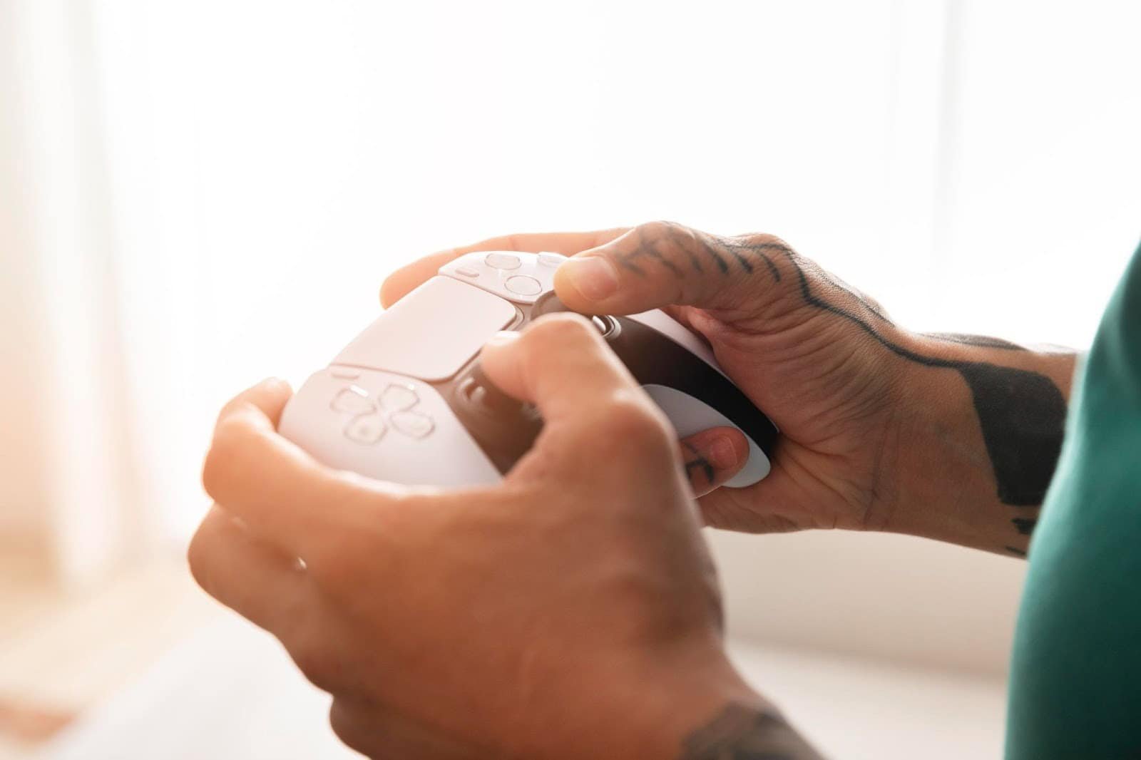 Player holding a DualSense controller while gaming