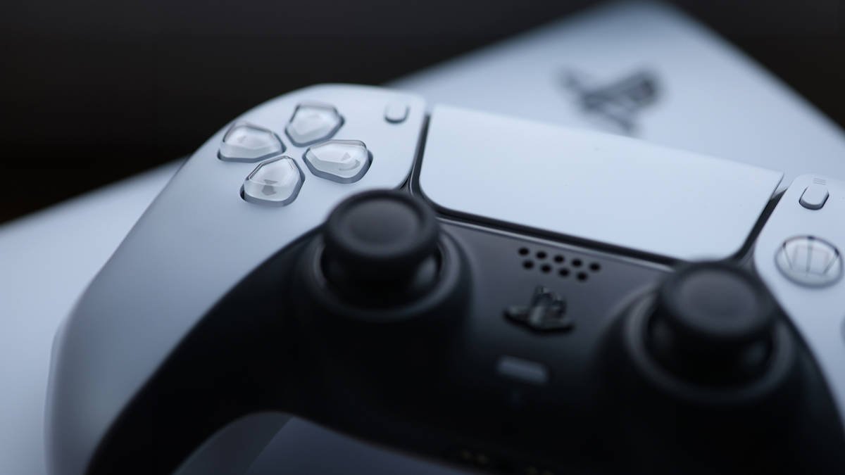 DualSense controller resting on top of a PS5 console