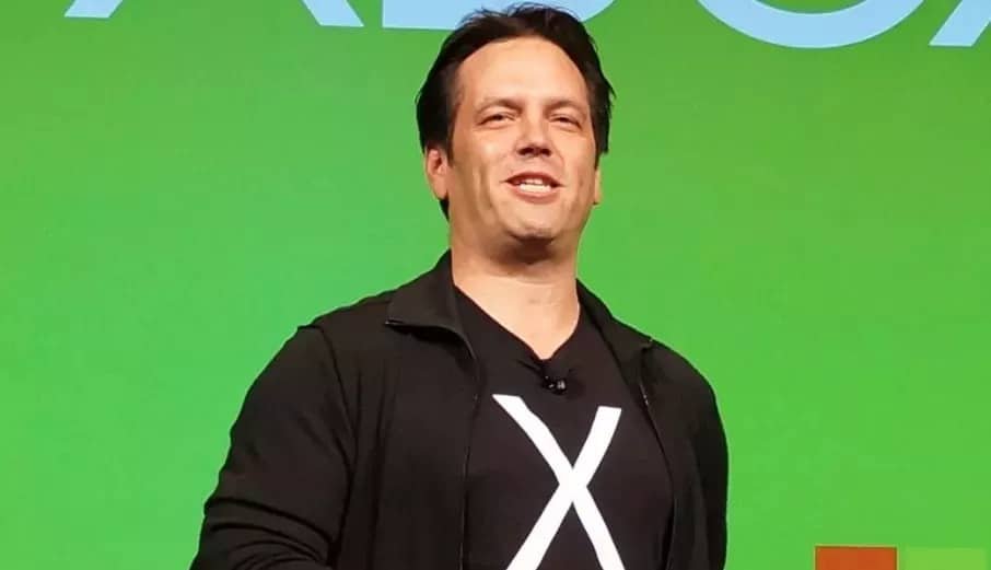Phil Spencer speaking at an event, headshot showing him in a dark jacket
