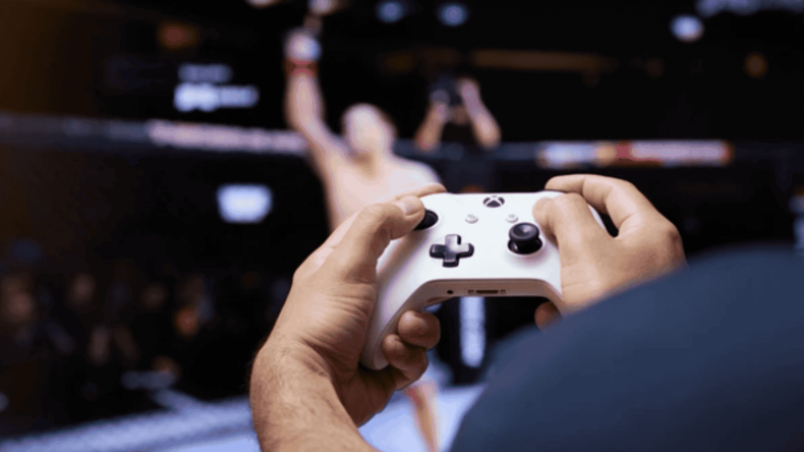 man playing a game on a TV using an Xbox controller
